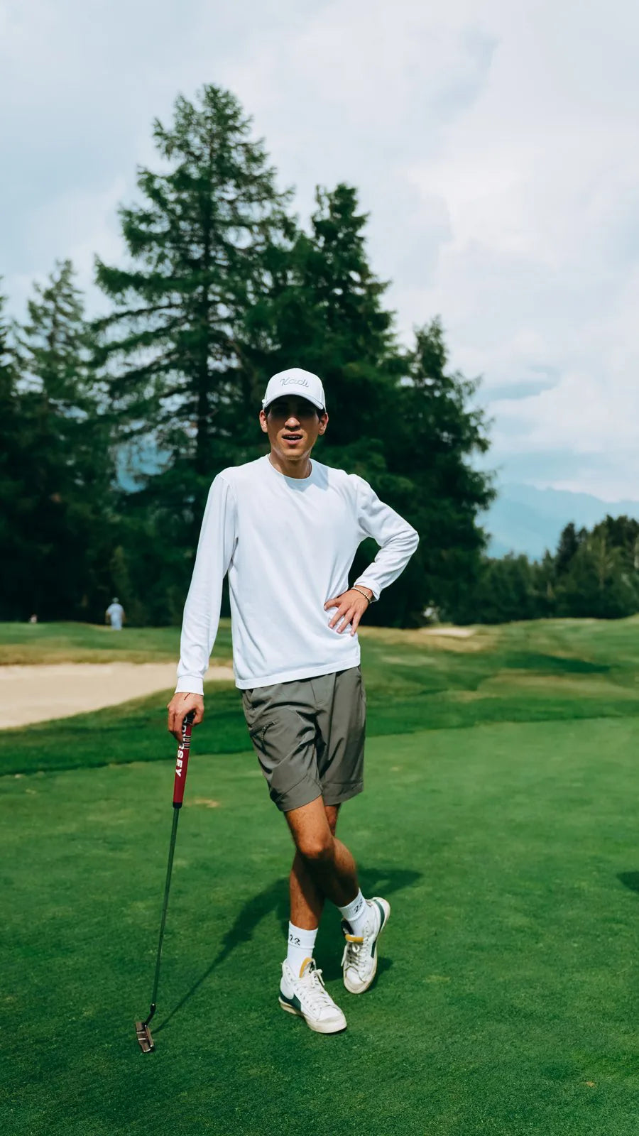Mehdi in a plain white KADI tee on the course
